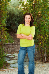 Hispanic woman smiling outside in nature.