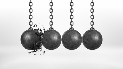 3d rendering of a set of four black iron wrecking balls handing from their chains where one ball is broken.