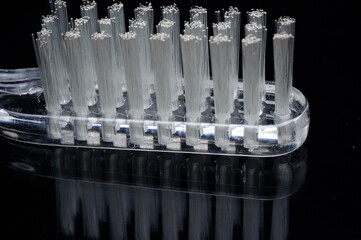close up of toothbrush isolated on black with reflection