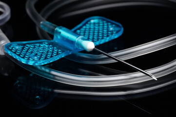 close up of medical butterfly needle isolated on black 