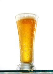 Glass of cold beer on a white background