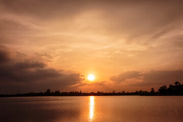 Fototapeta na wymiar dramatic sunset sky on the river