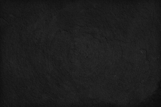 Black Stone background. Dark gray texture close up high quality May be used blank for design. Copy space © Ammak