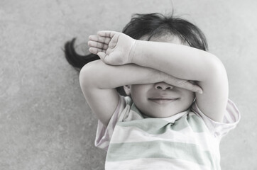 Fototapeta premium Little asian girl crying on the floor