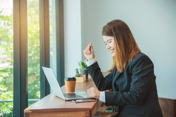 Young asian businesswoman using laptop computer in cafe