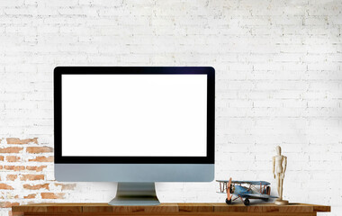 Mock up Desktop computer on wooden table with white brick wall. Blank screen for Graphic or product display montage.
