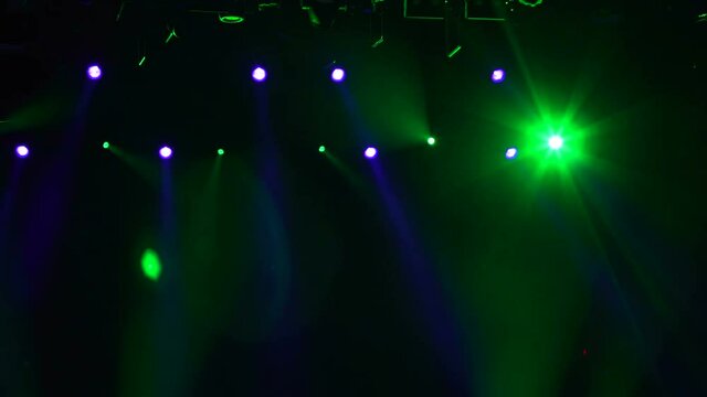 Spotlight, a few points of light on stage. Blurred lights a rock concert. 4k