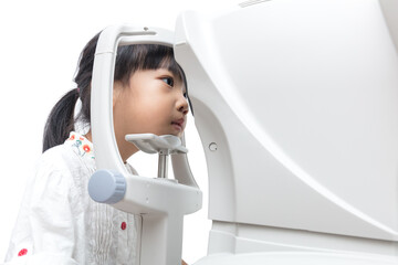 Asian Little Chinese Girl Doing Eyes Examination Through Auto refractometer