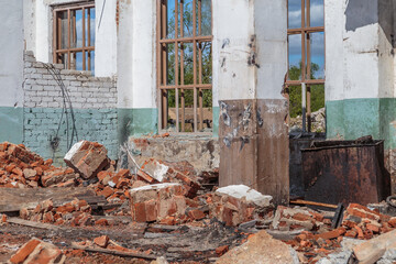 The fragments of red brick and plaster of the ruined house
