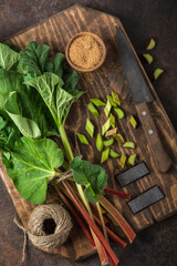 fresh organic rhubarb on wooden cutting board