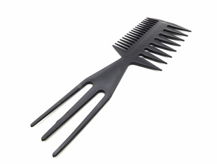 Black plastic comb close-up on a white background.