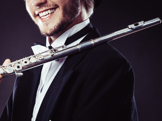 Elegantly dressed musician holding flute