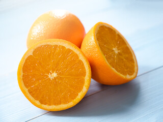 Fresh navel orange on light blue wooden ground