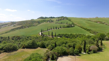 Amazing aerial view of Tuscany countryside winding road in spring season - Italy