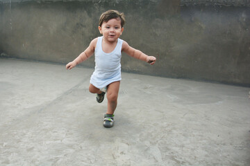 Happy baby boy running