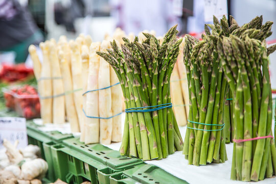Asparagus. Fresh bundles of white and green asparagus on market place.