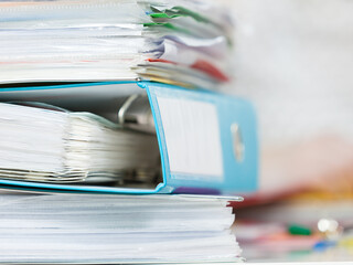 Stack of many binders with documents