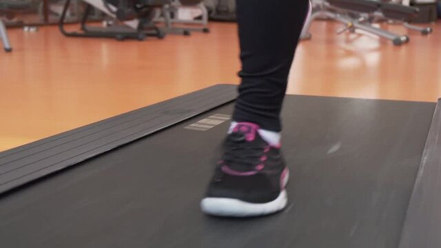 Young girl trains on a treadmill in gym slow motion stock footage video