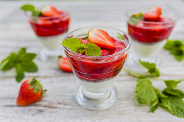 Yogurt with chia seeds and jelly and fresh strawberries.