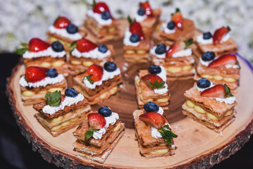 Delicious miniature berry cakes in buffet trays. Event dessert with delicious cakes for night party