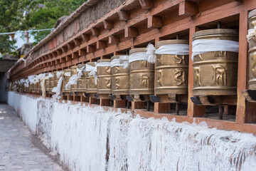 Fototapeta na wymiar Religious : golden prayer wheels in the temple at leh ladakh. Indian Asian