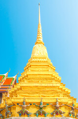 Giants under golden pagoda, Warrior statue at The Grand Palace and the temple Wat Phra Kaeo. Bangkok. Thailand.