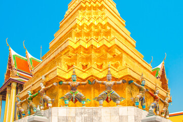 Giants under golden pagoda, Warrior statue at The Grand Palace and the temple Wat Phra Kaeo. Bangkok. Thailand.