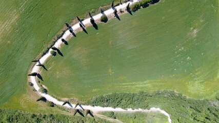 Amazing aerial view of Tuscany countryside winding road in spring season - Italy