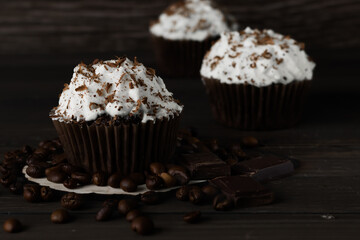 Chocolate-coffee cupcakes on a dark wooden background