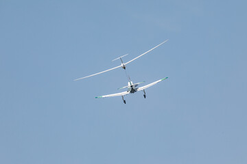 Fototapeta na wymiar Plane pulling of a glider, a small sports plane pulls a glider into the cloud.