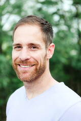 Fototapeta premium Portrait of a casual bearded man in a park