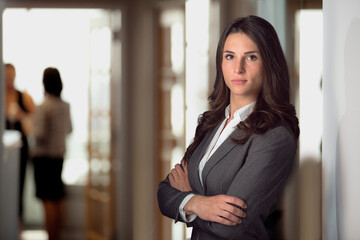 Strong female lawyer standing confident at office firm looking tough resilient with pride for justice