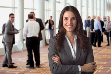 Cheerful corporate employee attending a leadership business seminar in a conference room