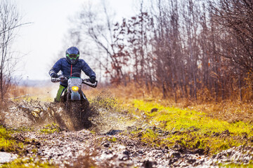 Obraz premium Enduro bike rider on dirt track