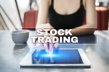 Woman using tablet pc and selecting stock trading.