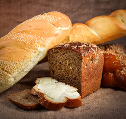 still life of bread and millet in old style on a linen cloth with a distinct texture. The figure also oil and grain cereals and eggs.