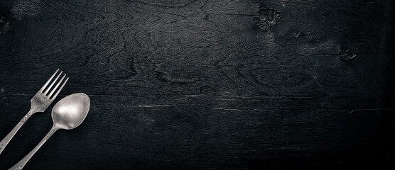 Cutlery. Fork and spoon. On Wooden background. Top view.