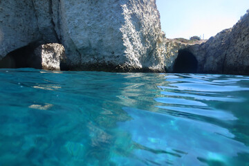 Photo of volcanic island of Milos with clear waters and caves, Cyclades, Greece