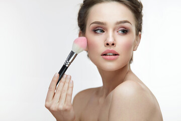 Facial Beauty Cosmetics. Sexy Woman Applying Blush With Brush