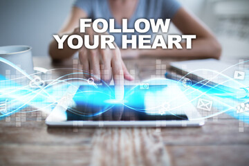 Woman using tablet pc, pressing on virtual screen and selecting follow your heart.