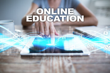 Woman using tablet pc, pressing on virtual screen and selecting online education.