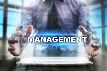 Fototapeta na wymiar Businessman using tablet pc and selecting management.