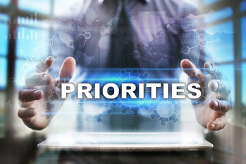 Businessman using tablet pc and selecting priorities.