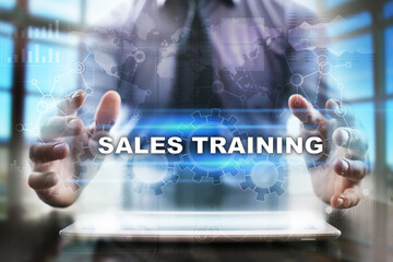 Fototapeta na wymiar Businessman using tablet pc and selecting sales training.