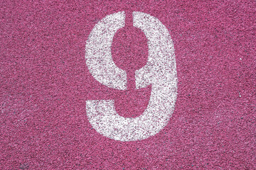 Number nine ninth 9  on the start of a running track