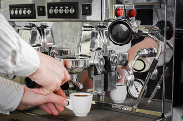 cooked cup of espresso coffee machine is on
