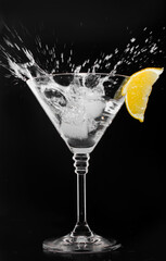 A glass with vermouth and ice cube on a black background