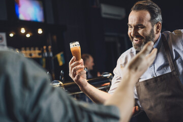 Brewery worker with glass of beer