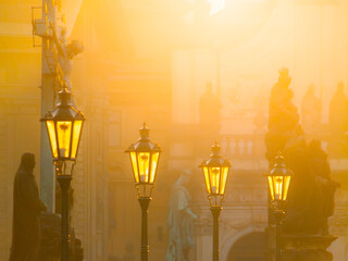 Street lamps on Charles bridge illuminated by sun in the morning, Old Town, Prague, Czech Republic.