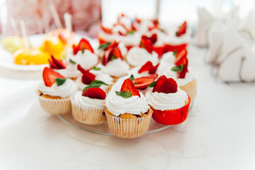 Candy bar. Wedding table with sweets, cupcakes
